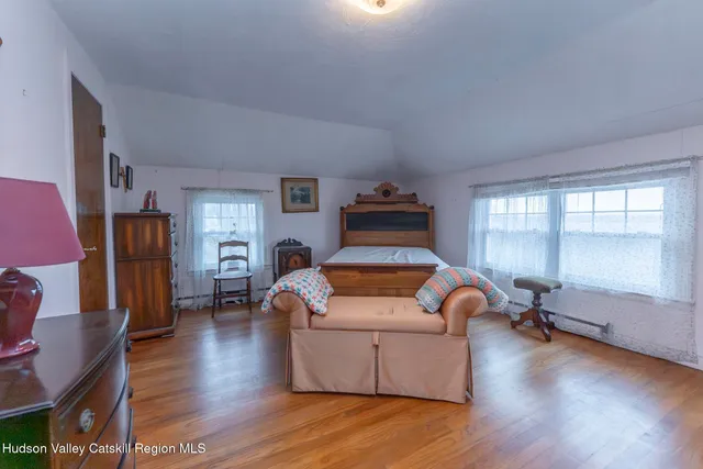 a living room with furniture window and wooden floor