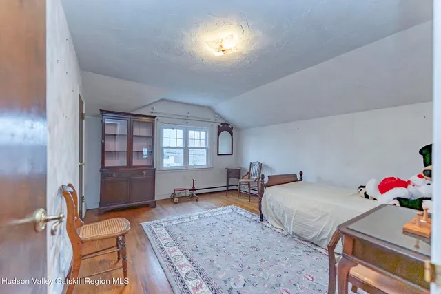 a bedroom with furniture and a window