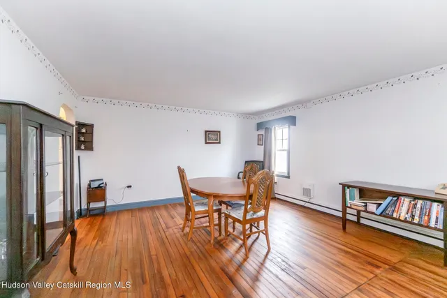 a dining room with furniture and wooden floor