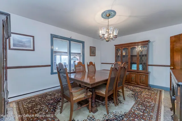 a view of a dining room with furniture and window