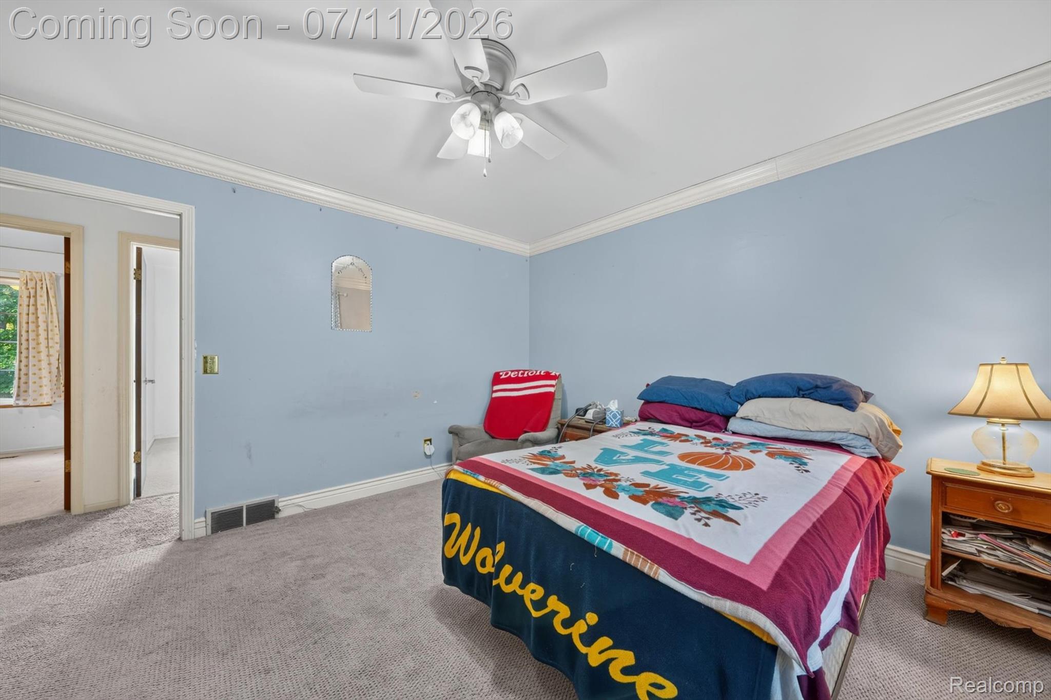 4430 North Center Road Flint, MI 48506 - Photo 24 of 49 Carpeted bedroom featuring crown molding, a ceiling fan with light fixture, and a light blue wall finish