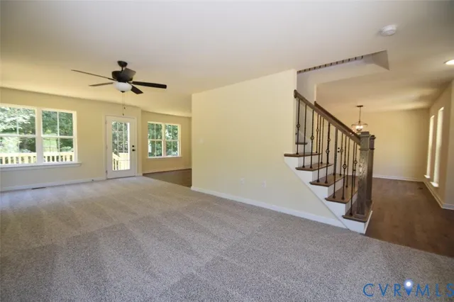 a view of staircase with wooden floor and white walls