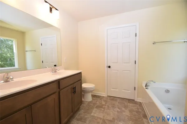 a bathroom with a double vanity sink toilet and shower