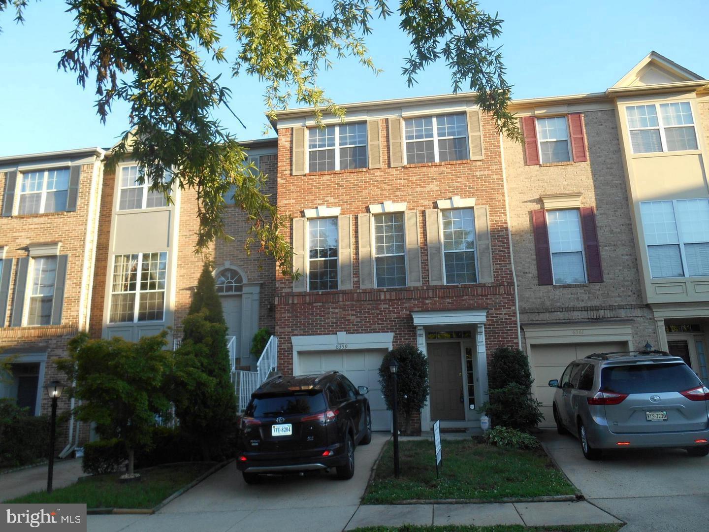 6359 Battlement Way Alexandria, VA 22312 - Photo 2 of 19 a car parked in front of a brick house