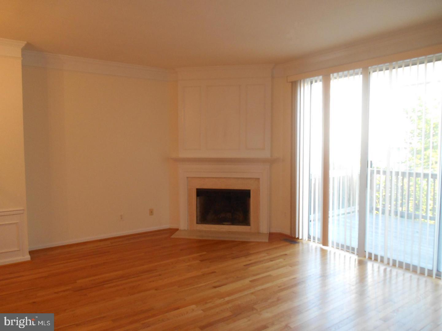 6359 Battlement Way Alexandria, VA 22312 - Photo 4 of 19 a view of empty room with wooden floor and fireplace