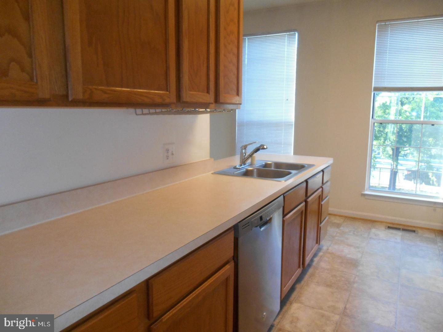 6359 Battlement Way Alexandria, VA 22312 - Photo 7 of 19 a kitchen with a sink cabinets and a window