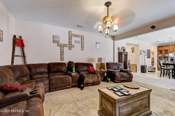 a living room with furniture a rug and a chandelier