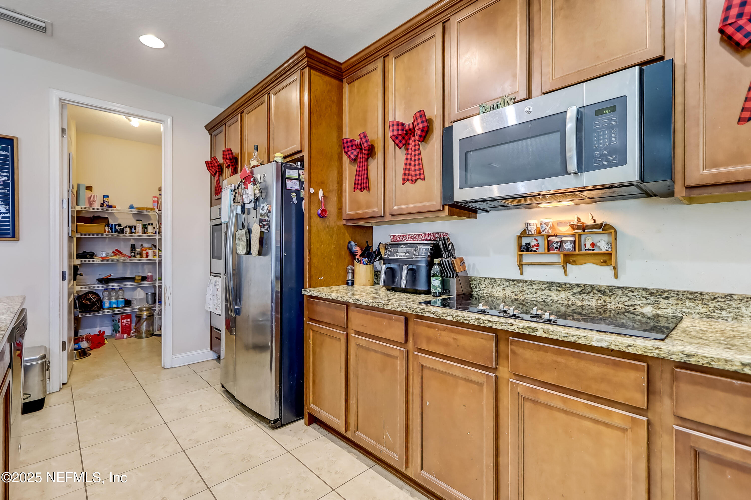 1071 Wetland Ridge Circle Middleburg, FL 32068 - Photo 16 of 41 a kitchen with stainless steel appliances granite countertop a refrigerator and a sink