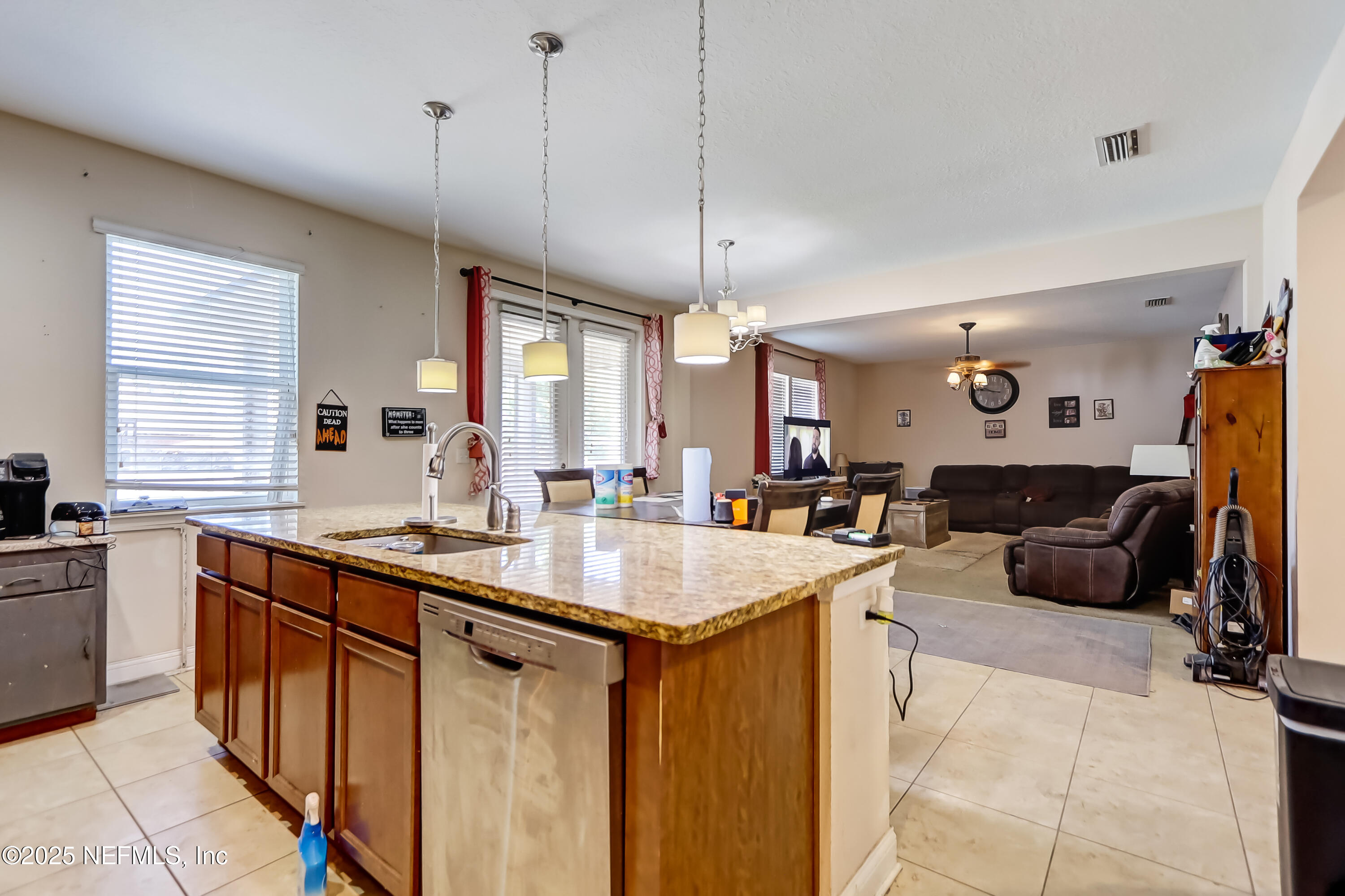 1071 Wetland Ridge Circle Middleburg, FL 32068 - Photo 17 of 41 a kitchen with lots of counter space a sink a window and living room view