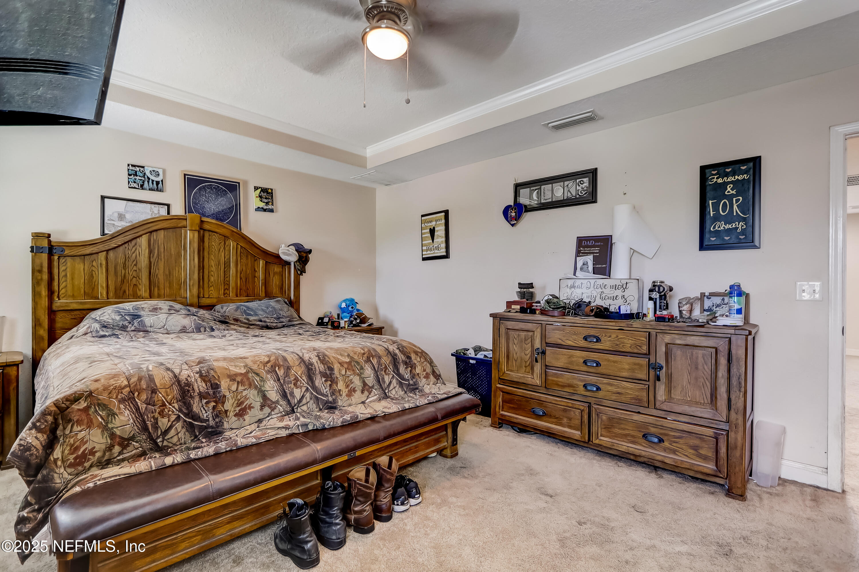 1071 Wetland Ridge Circle Middleburg, FL 32068 - Photo 21 of 41 a bedroom with a bed and a chandelier