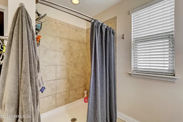 a bathroom with a shower and a tub