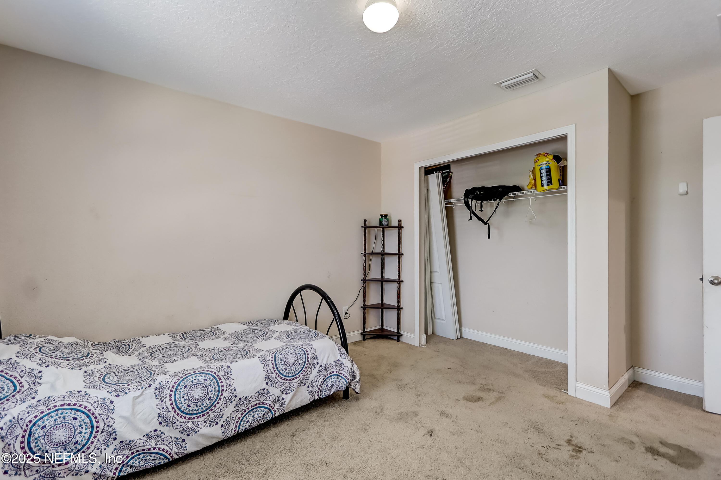 1071 Wetland Ridge Circle Middleburg, FL 32068 - Photo 30 of 41 a bedroom with a bed and a painting on the wall