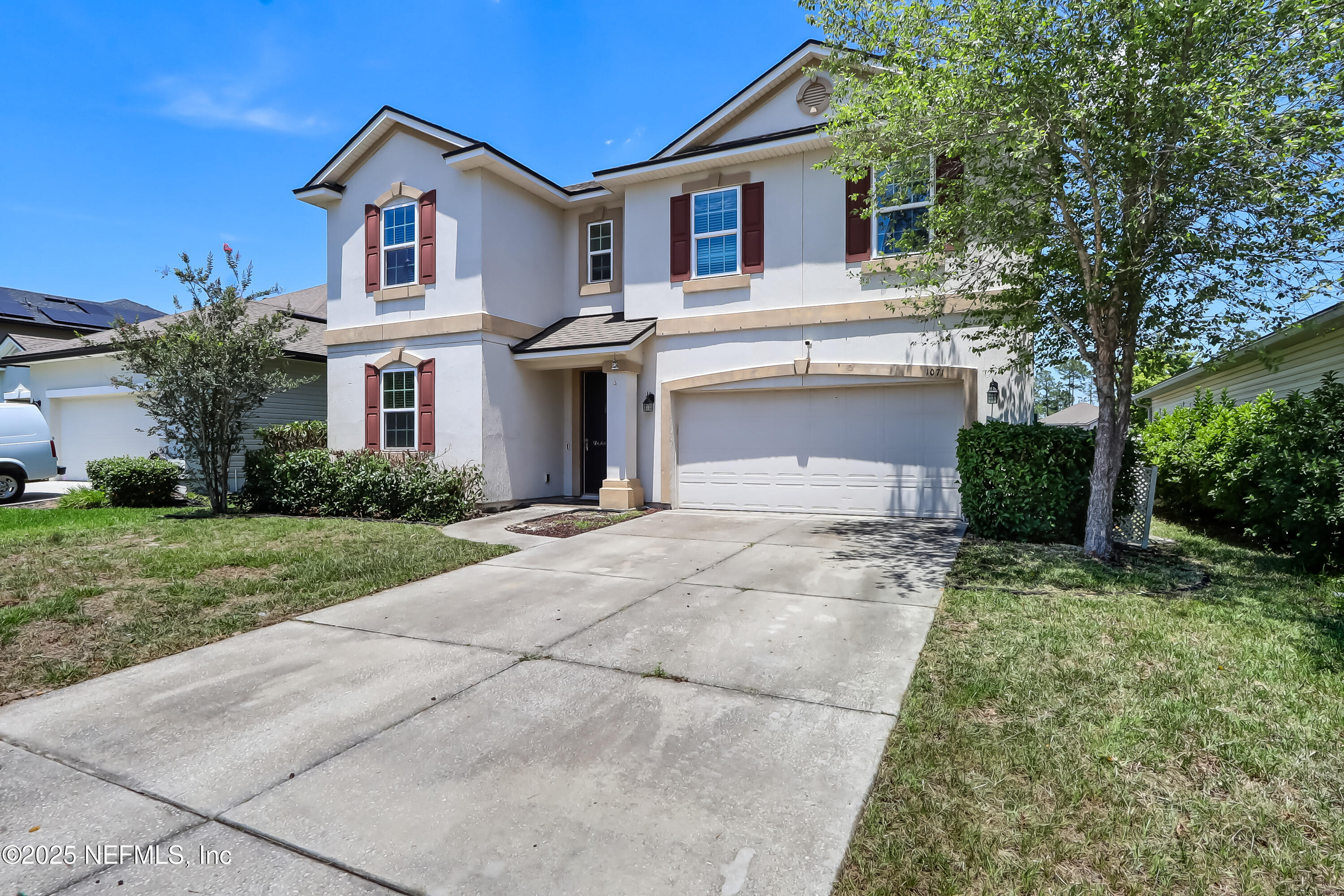 1071 Wetland Ridge Circle Middleburg, FL 32068 - Photo 3 of 41 a front view of a house with a yard and trees