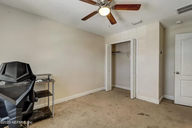 a view of a porch with furniture and a yard