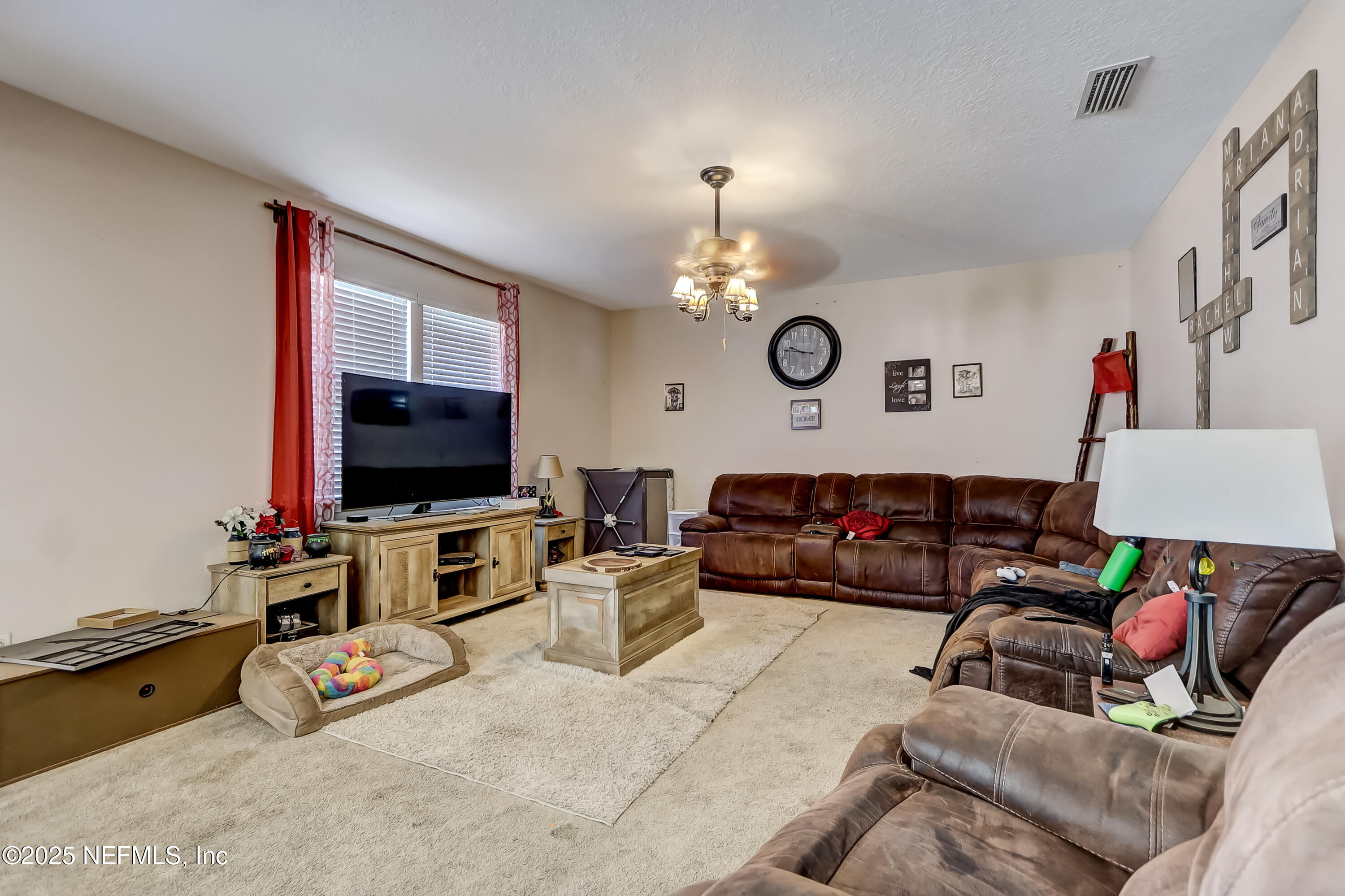 1071 Wetland Ridge Circle Middleburg, FL 32068 - Photo 10 of 41 a living room with furniture and a flat screen tv