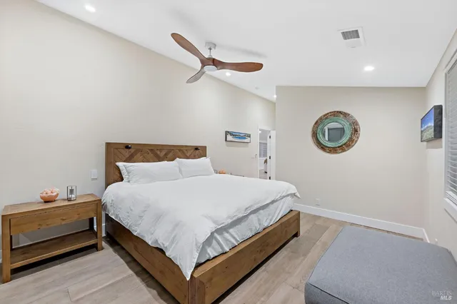 a bedroom with a bed and a lamp