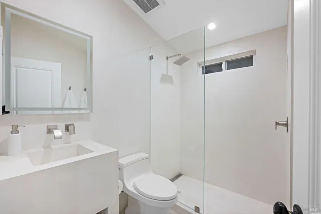 a white toilet sitting next to a bathroom sink