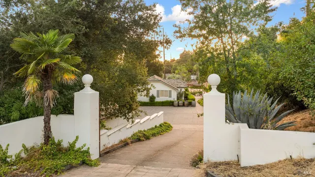 a front view of a house with a yard and tree s