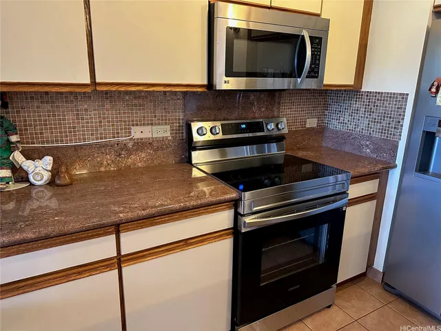 a kitchen with a stove and a microwave