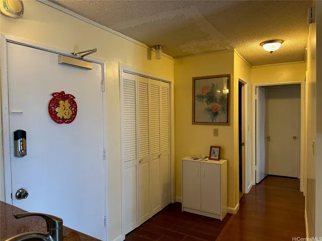 a view of a hallway with wooden floor