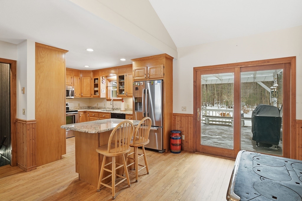 9 East Hill Road Monson, MA 01057 - Photo 16 of 41 a view of a kitchen with kitchen island granite countertop wooden floor and stainless steel appliances