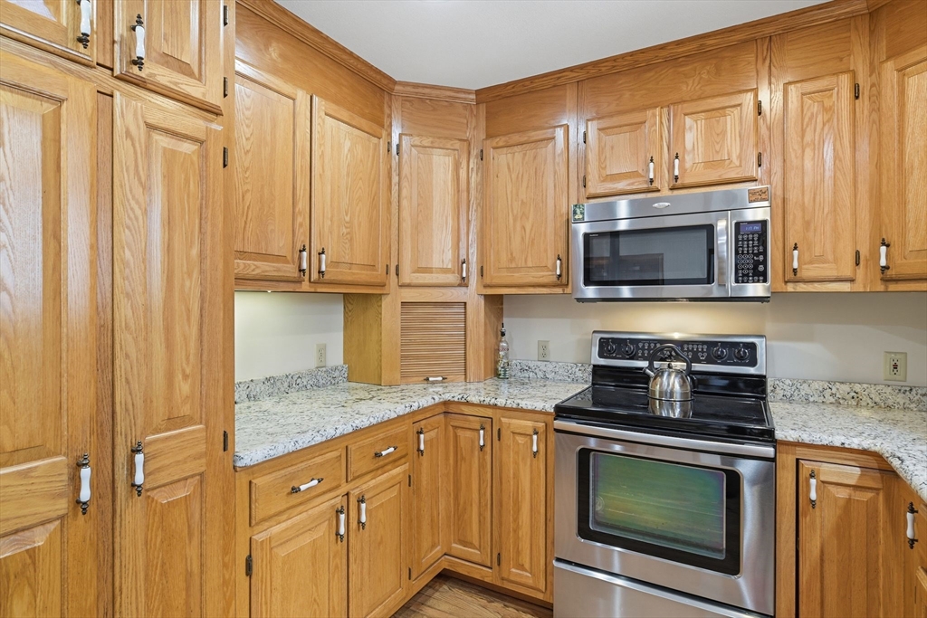 9 East Hill Road Monson, MA 01057 - Photo 20 of 41 a kitchen with stainless steel appliances granite countertop a stove microwave and cabinets