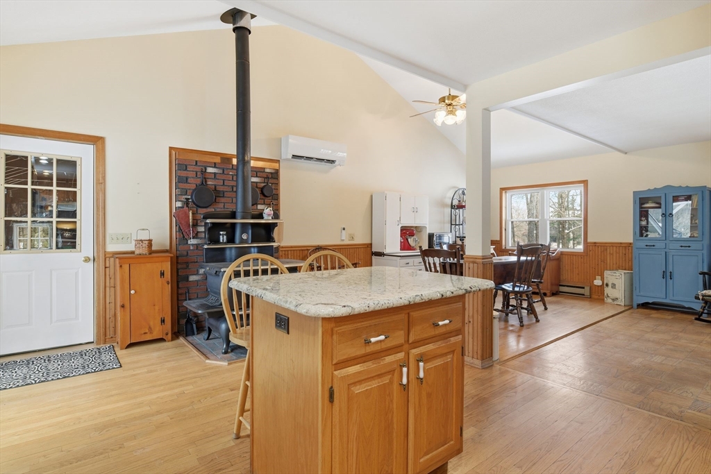 9 East Hill Road Monson, MA 01057 - Photo 21 of 41 a kitchen with a stove a sink a dining table and chairs