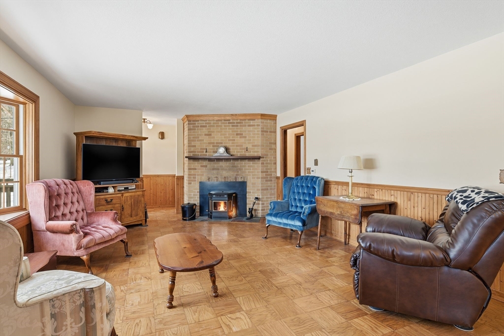9 East Hill Road Monson, MA 01057 - Photo 9 of 41 a living room with furniture a fireplace and a flat screen tv