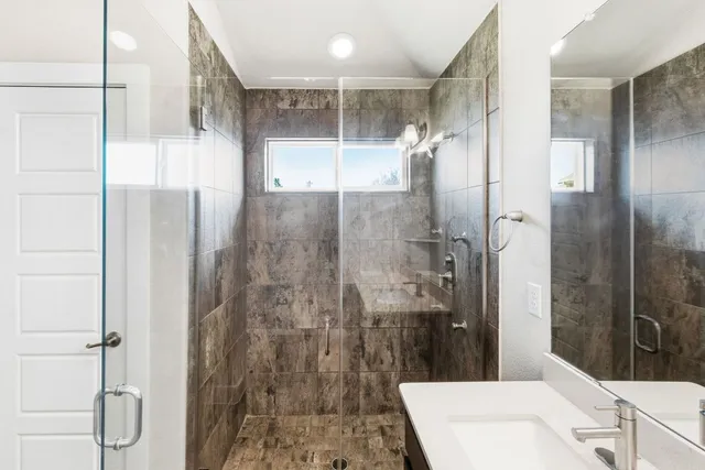 a bathroom with a sink double vanity and a mirror