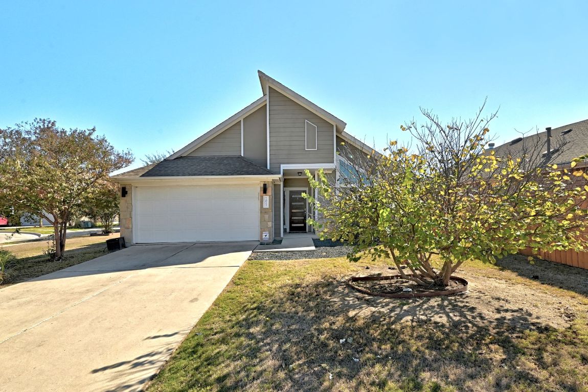 7013 Brick Slope Path Austin, TX 78744 - Photo 2 of 28 View of front of property with concrete driveway, a garage, and roof with shingles
