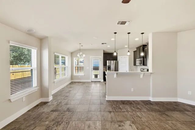 a view of a big room with windows and entryway