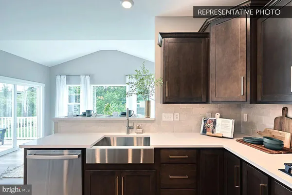 a kitchen with a sink a counter top space a stove and cabinets