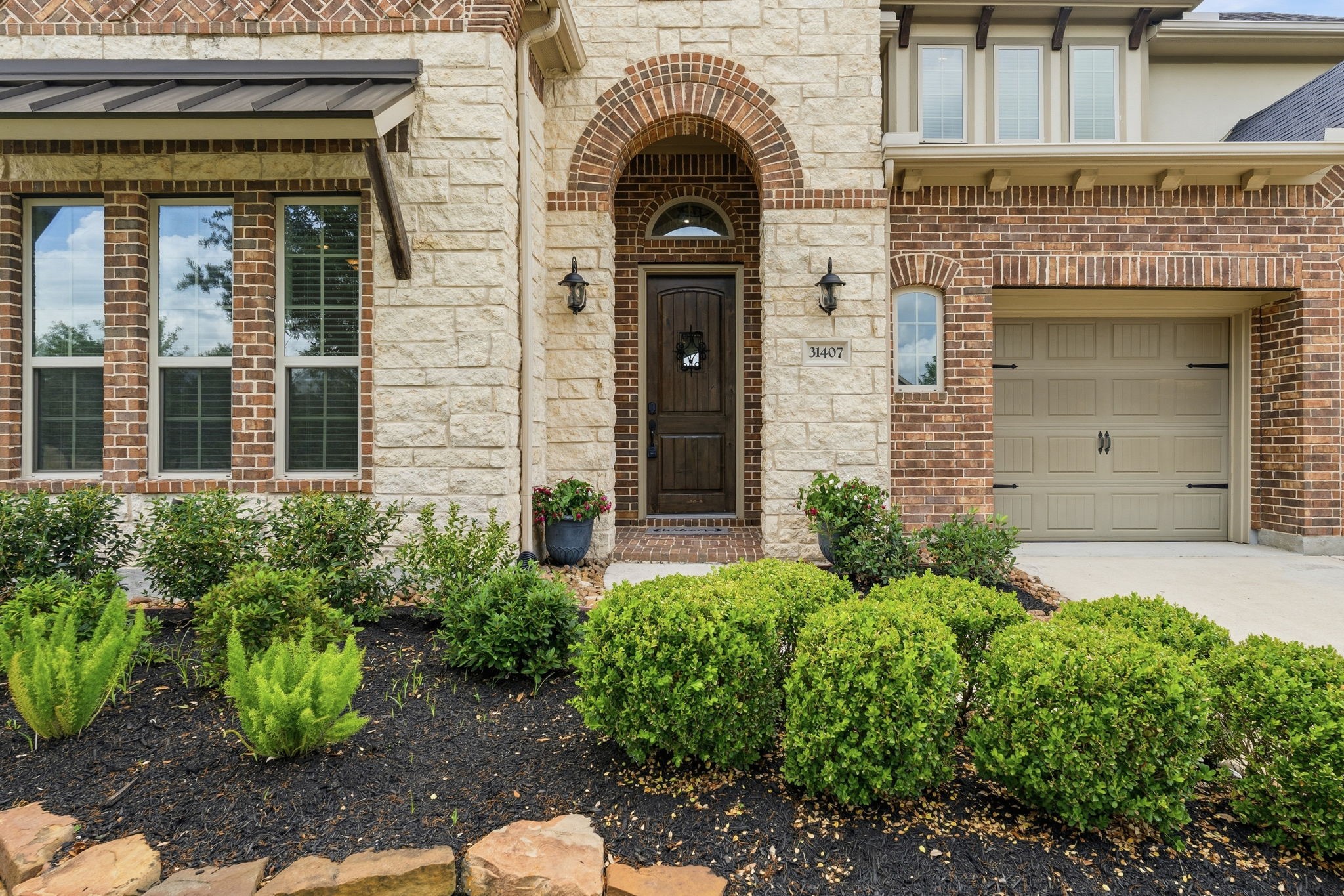 31407 Falling Cedar Court Spring, TX 77386 - Photo 2 of 47 Notice all the details in the stone, brick, archways and metal awnings!