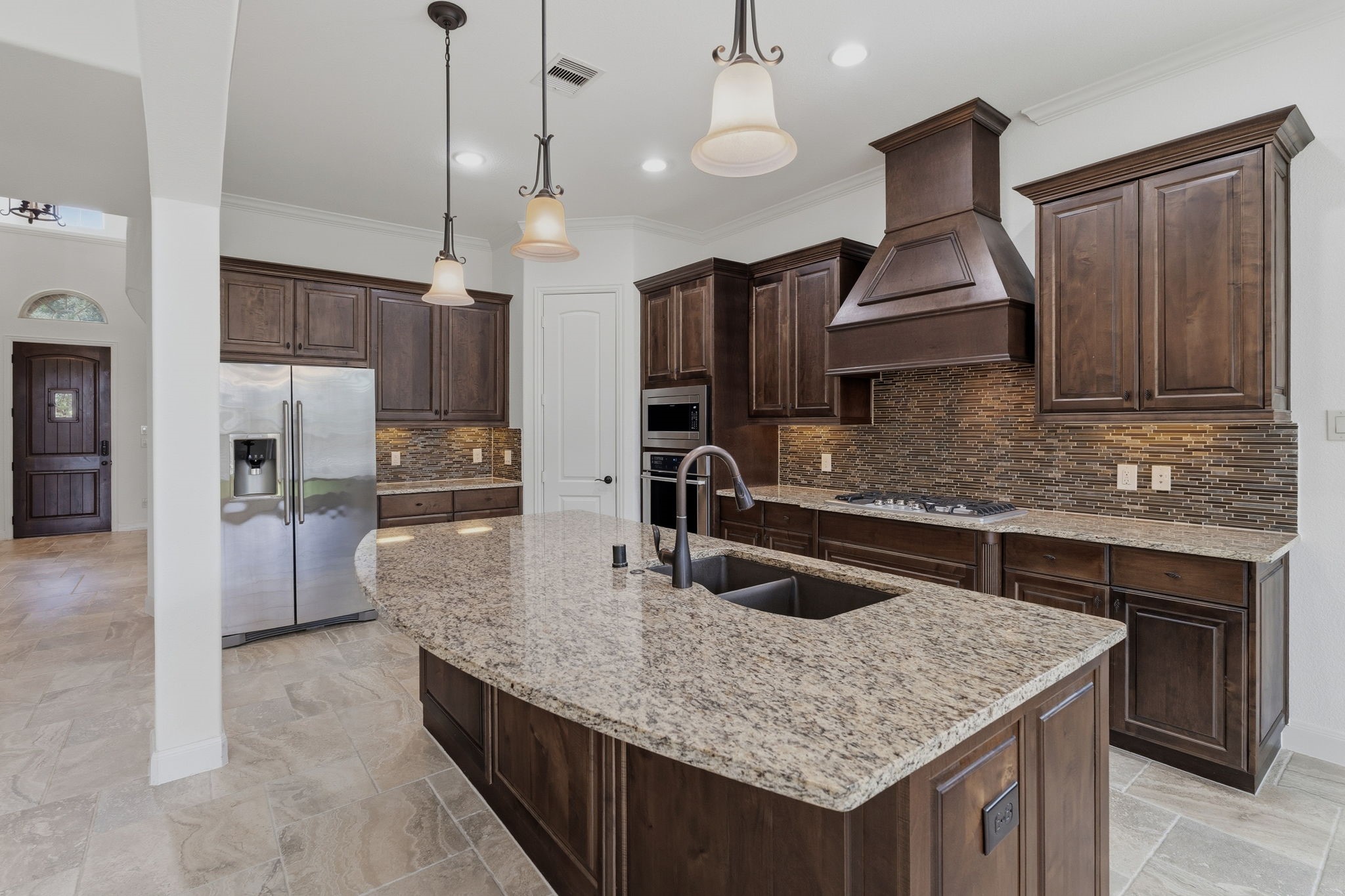 31407 Falling Cedar Court Spring, TX 77386 - Photo 6 of 47 This kitchen offers an abundance of granite counters and cabinets for storage. The door in the corner is to the walk in pantry!