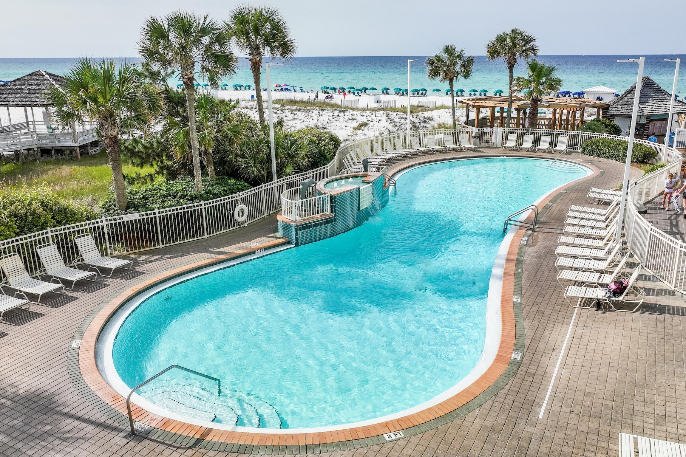 970 Highway 98, Unit 303 Destin, FL 32541 - Photo 14 of 42 a view of a swimming pool with a lounge chairs
