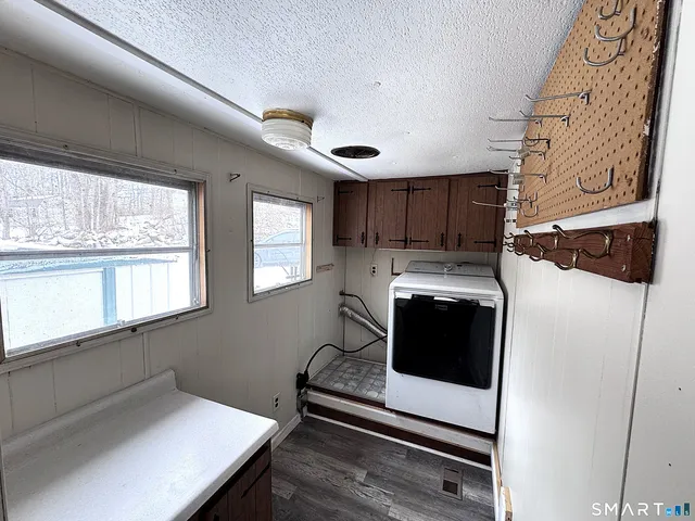 a kitchen with stainless steel appliances a stove a microwave and white cabinets