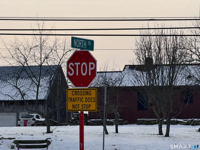 a street sign on a pole next to a road