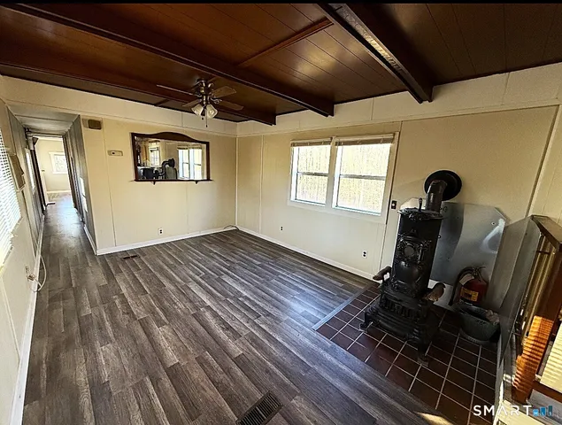 a view of a room with wooden floor
