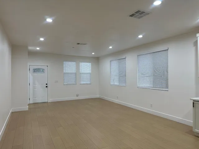 an empty room with windows and closet