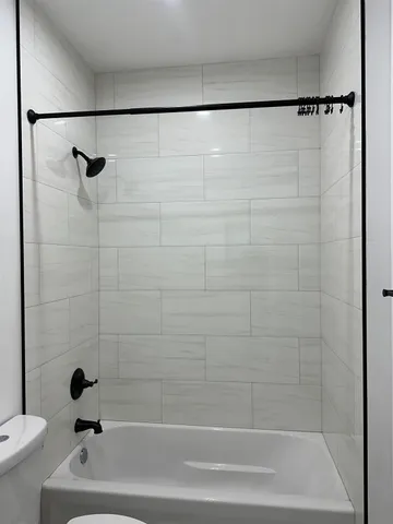 a bathroom with a shower and a bathtub