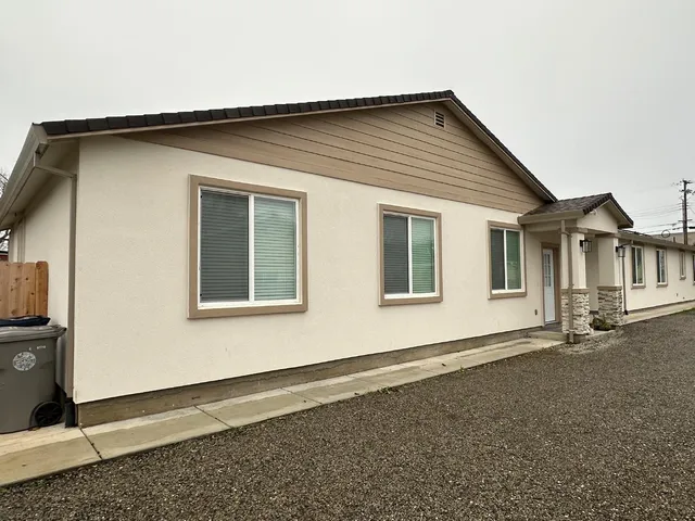 a front view of a house with a garden