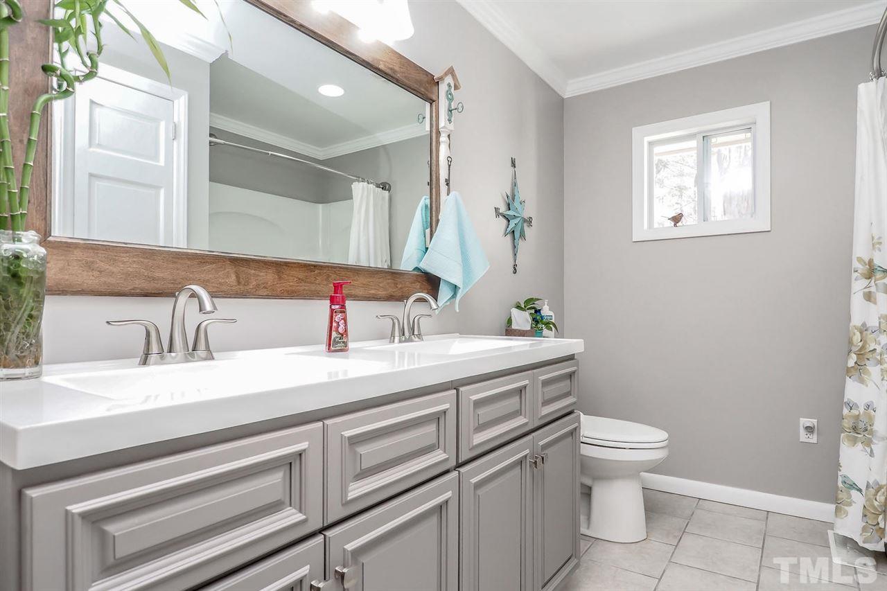 12345 Creedmoor Road Raleigh, NC 27613 - Photo 13 of 25 a bathroom with a toilet sink and mirror