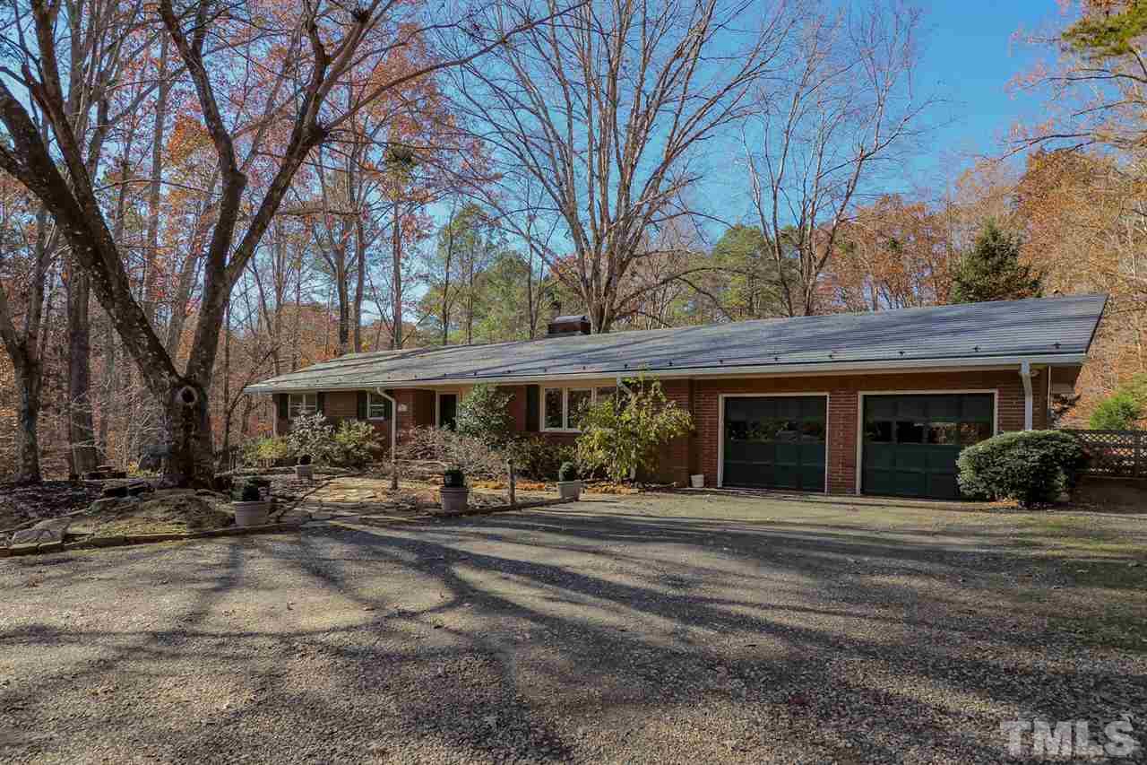 12345 Creedmoor Road Raleigh, NC 27613 - Photo 2 of 25 a front view of a building with large trees and lawn chairs