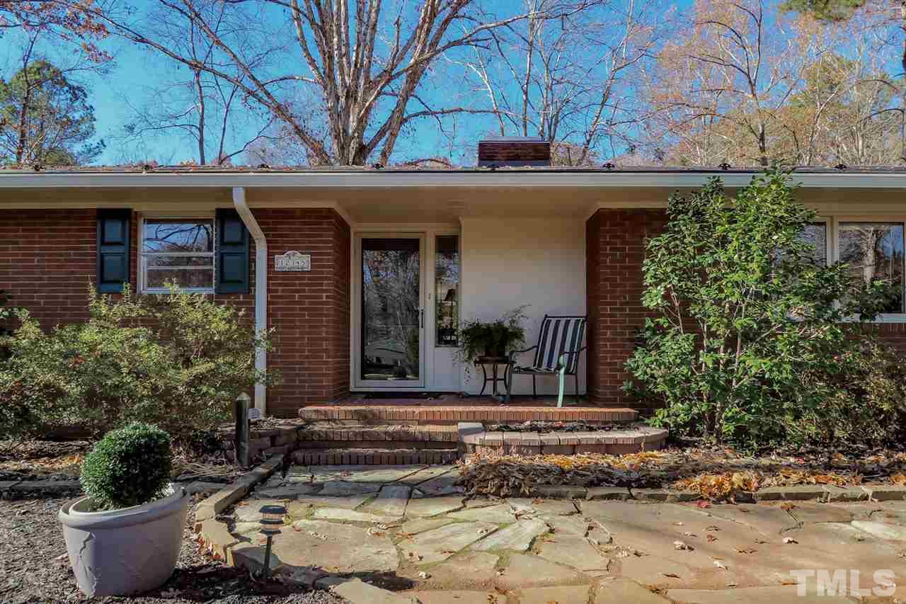 12345 Creedmoor Road Raleigh, NC 27613 - Photo 3 of 25 a view of a house with potted plants and a fountain