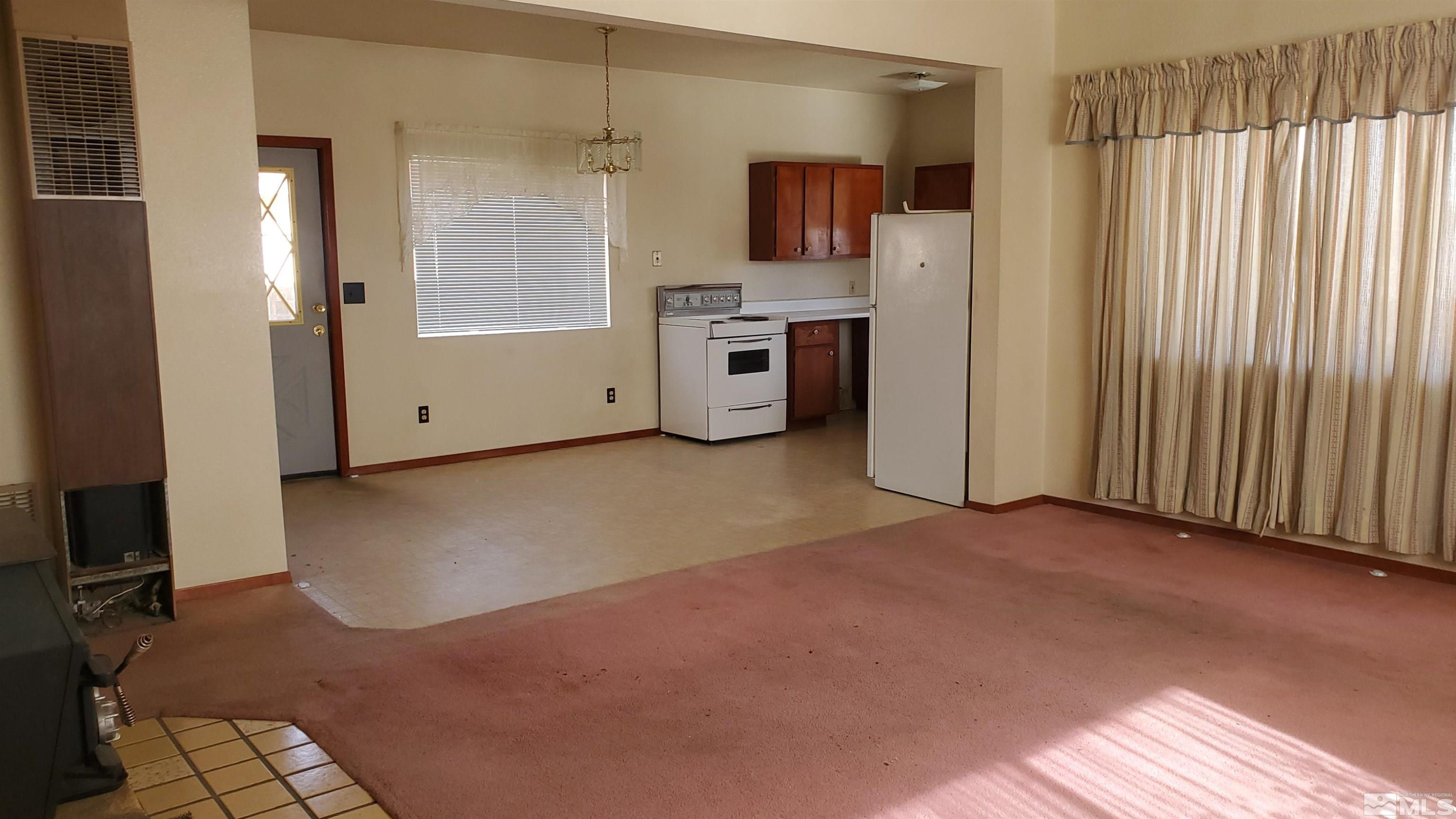223 I Street Hawthorne, NV 89415 - Photo 11 of 13 a view of a kitchen with refrigerator and cabinet