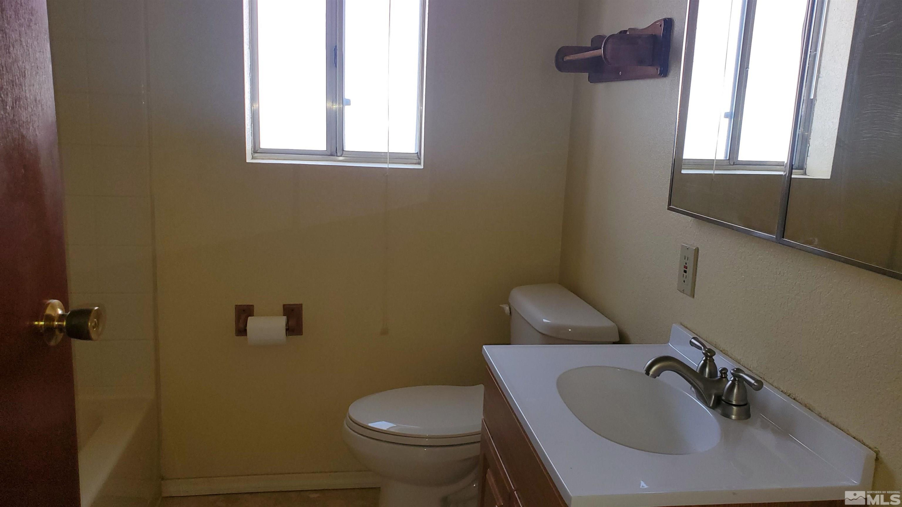 223 I Street Hawthorne, NV 89415 - Photo 8 of 13 a bathroom with a sink and a toilet