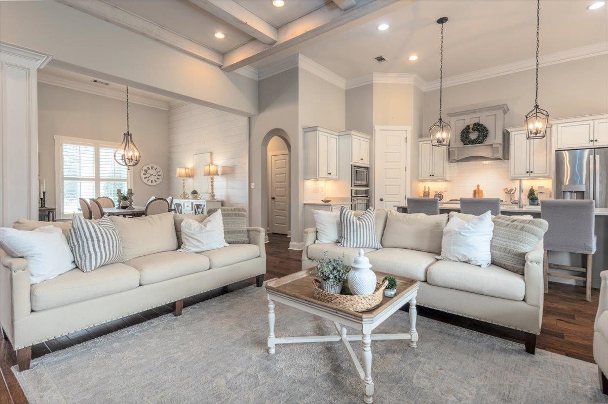 608 Cypress Run Cove Collierville, TN 38017 - Photo 7 of 40 Living room with suspended lighting, wood finished floors, crown molding, and arched walkways