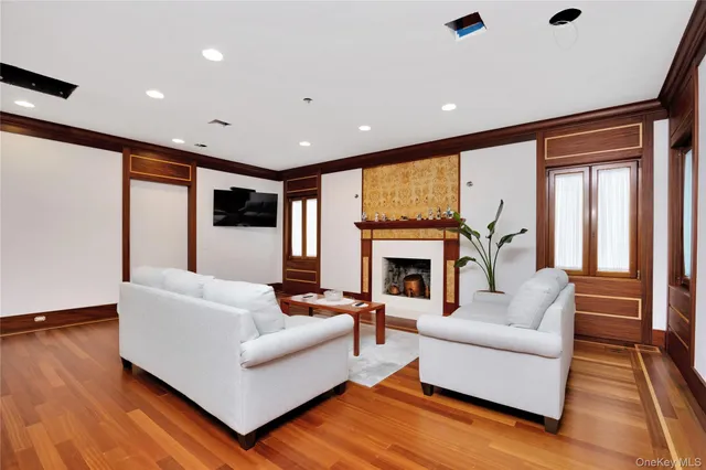 a living room with fireplace furniture and a wooden floor
