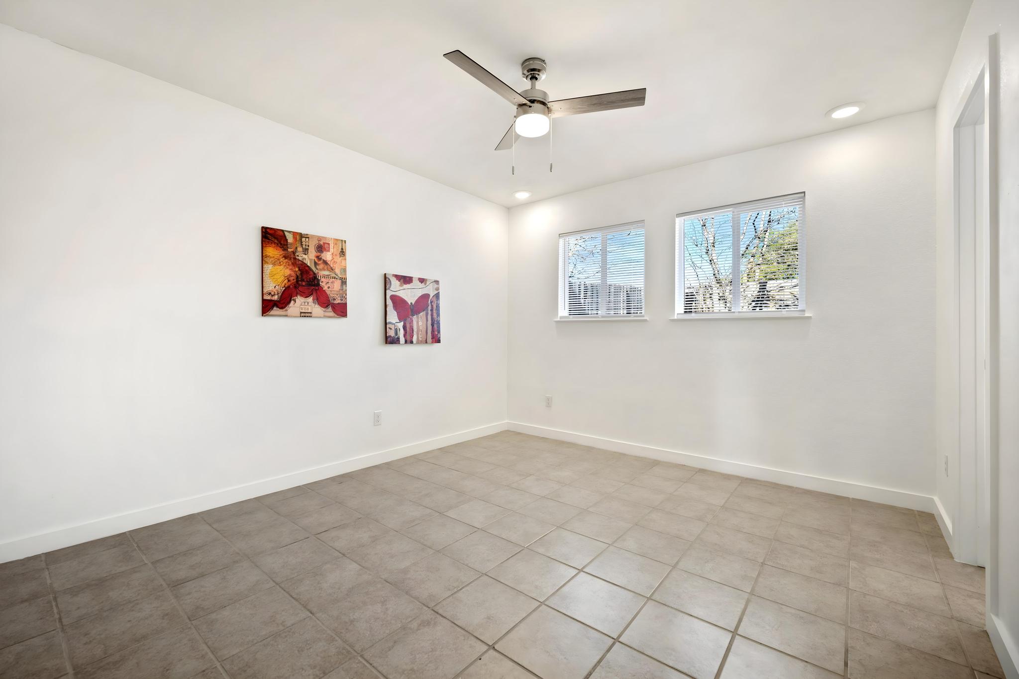 2614 Howellwood Way, Unit B Austin, TX 78748 - Photo 16 of 24 an empty room with windows and ceiling fan