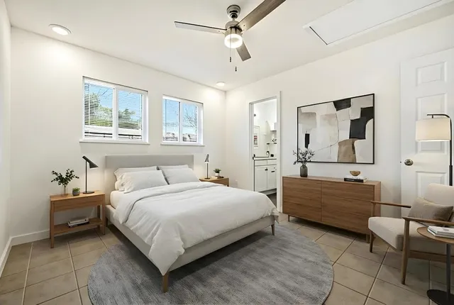 an empty room with fan and windows